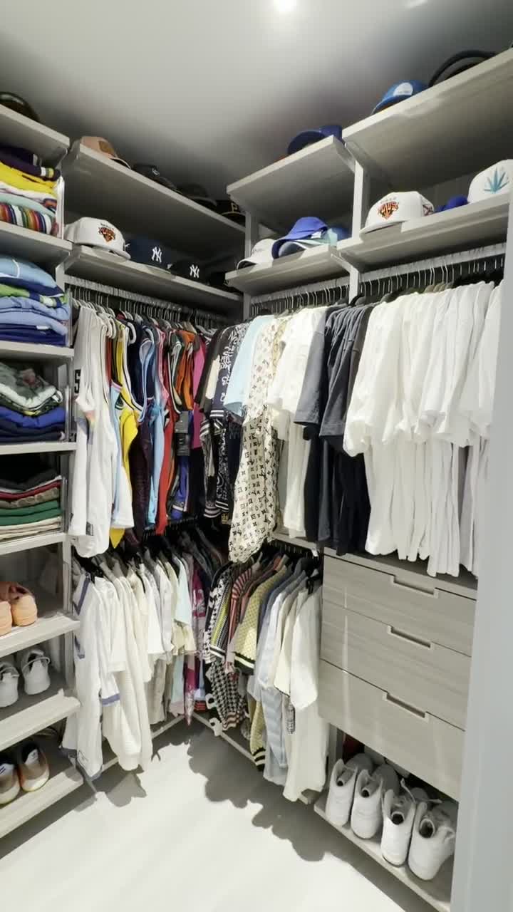 The finished closet: a jersey and graphic tee collection hung in order, caps displayed above, shoes lined up below.